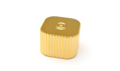 Gold plastic perfume cap with added weight